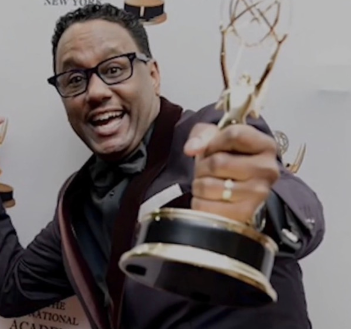 Mario Armstrong holding an Emmy Award